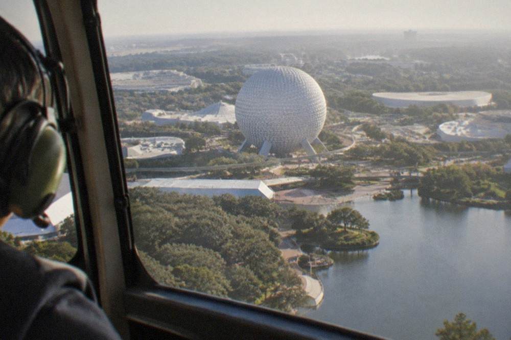A family tour helicopter flying above Orlando resort lakes and tree lines
