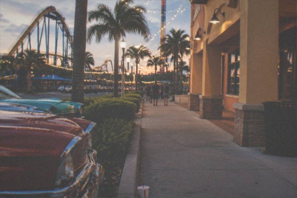 String lights and evening crowds along a walkable outdoor shopping and dining district