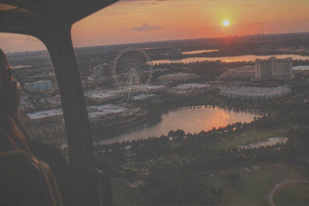 Sunset aerial view over Florida lakes and resort rooftops with warm orange light