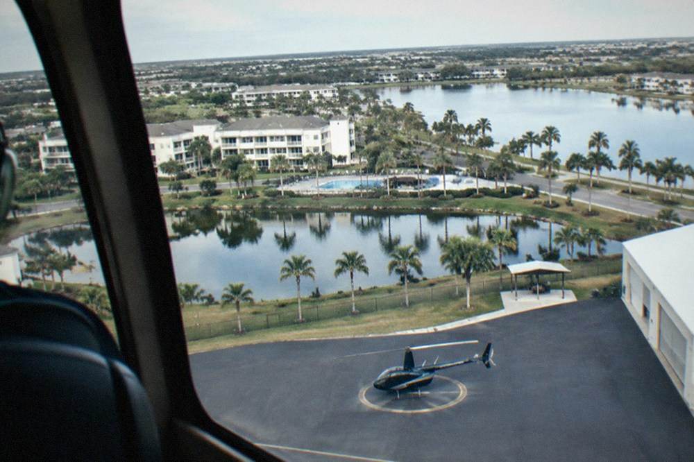 Aerial view of lakes and resort buildings near Kissimmee seen from a helicopter window