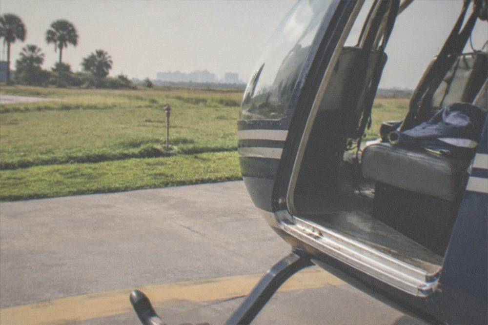 An open helicopter cabin doorway on a sunny Florida helipad