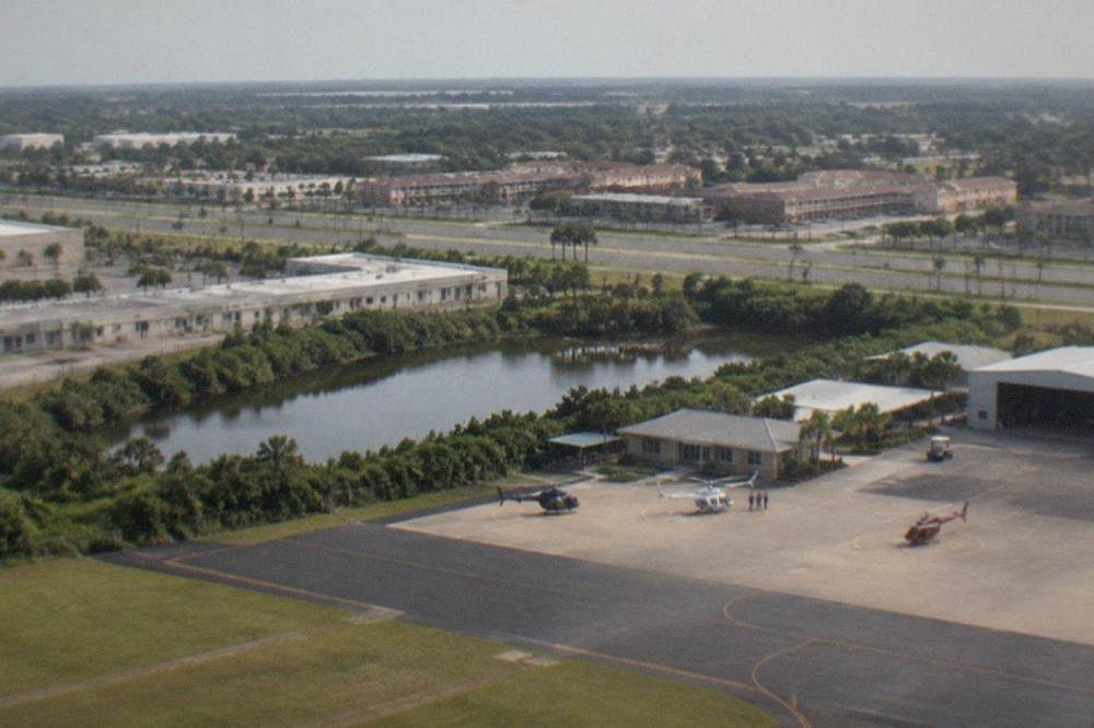 Aerial view of the US-192 highway corridor in Kissimmee with hotels and theme-park attractions along the roadside