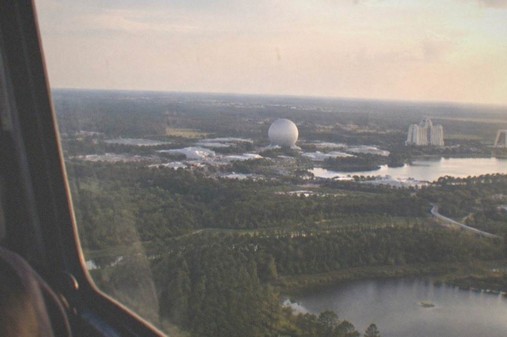 Distant theme-park resort towers and geodesic sphere on the horizon as seen from a helicopter outside the restricted airspace