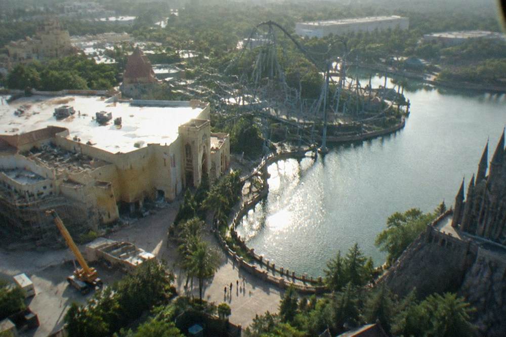 Aerial view of theme park towers and resort buildings across the Orlando corridor