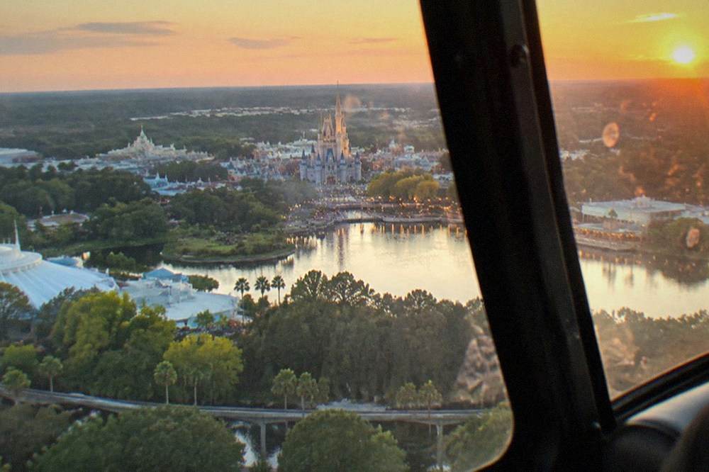 Theme park resort towers and lake seen from a helicopter window at a legal distance