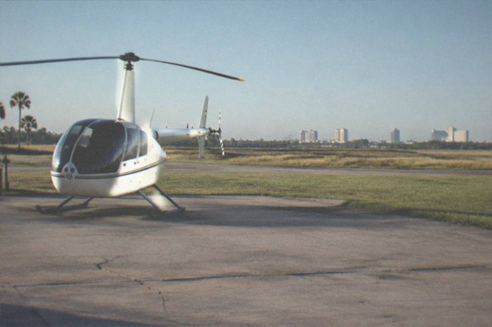 Helicopter at a Kissimmee heliport with the theme park corridor on the horizon